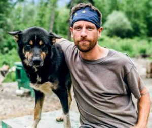 Image of Life Below Zero cast Jessie Holmes with his dog